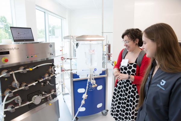 Attendees toured the 25,000-square-foot flexible facility. Attendees walking around the facility