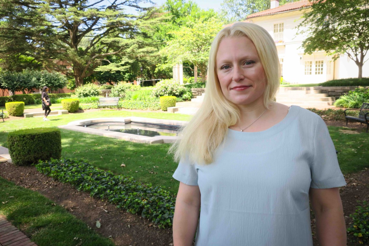 Student Amanda Alexander stands in front of the Reichlin House. 