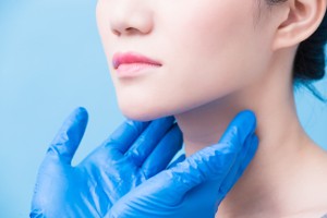 women with thyroid gland problem on the blue background
