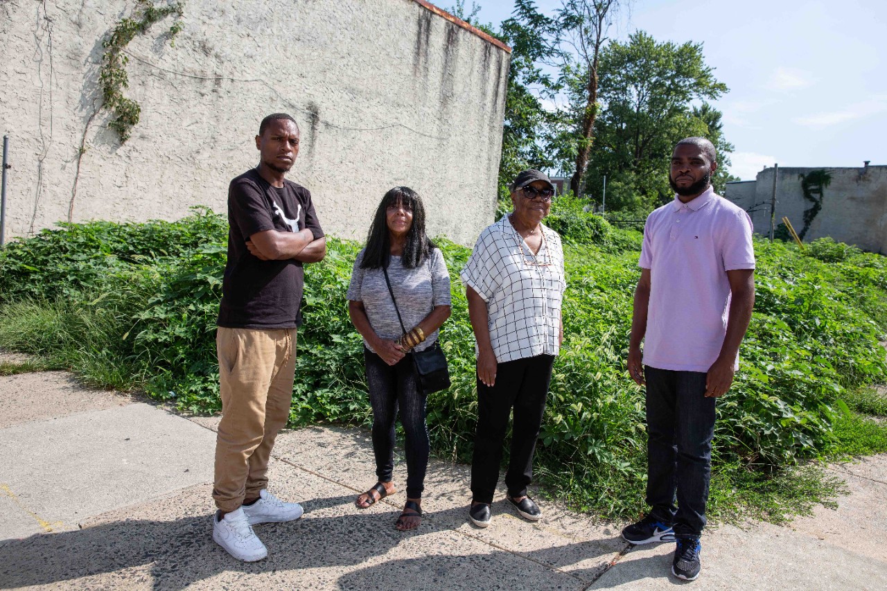 Mantua community members Nathaniel Mitchell, Camille Marion, Gwen Morris and De’Wayne Drummond stand in front of the lot where the first Park in a Truck will be built.