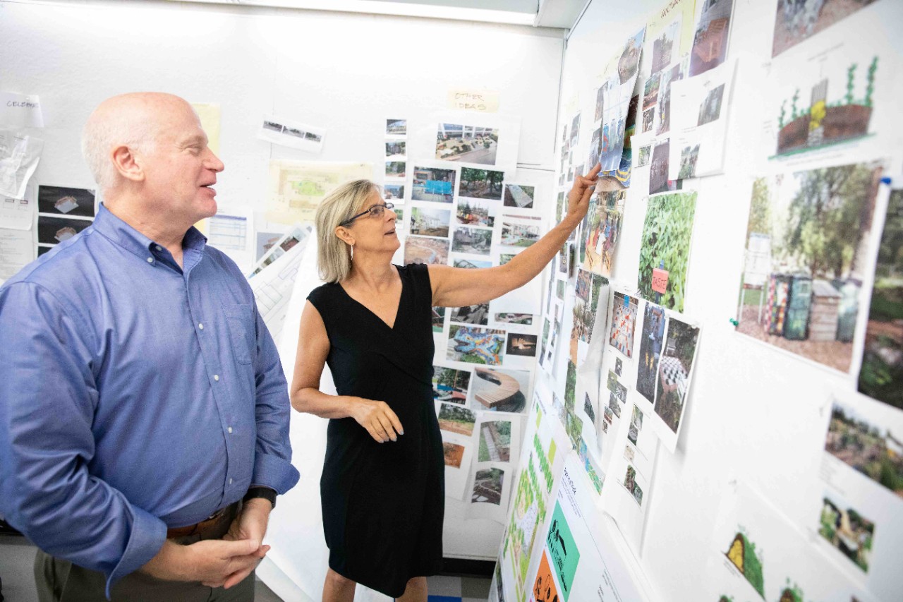 Jefferson faculty members Drew Harris and Kim Douglas stand by several posters