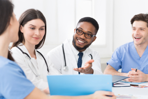 Medical staff having discussion in modern hospital meeting room, meeting of interns and practitioners