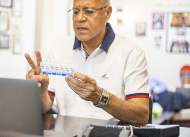 Middle Eastern man discussion medications over telehealth appointment