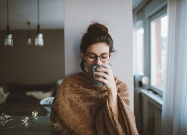 endometriosis woman drinking tea in a cozy sweater