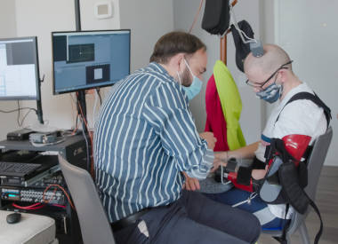 Mijail Serruya, MD, PhD, working with Cortimo patient to use brain implants to control a motorized brace fitted over his strok-affected arm. 