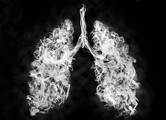 A pair of lungs made out of smoke on a black background