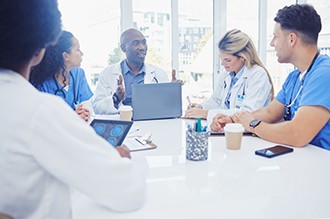 Healthcare, leader and black man in meeting, staff and brainstorming for schedule, deadline and innovation. African American male, staff or group share ideas, laptop or teamwork for procedure or cure.