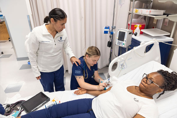 Nursing students and faculty in a learning setting