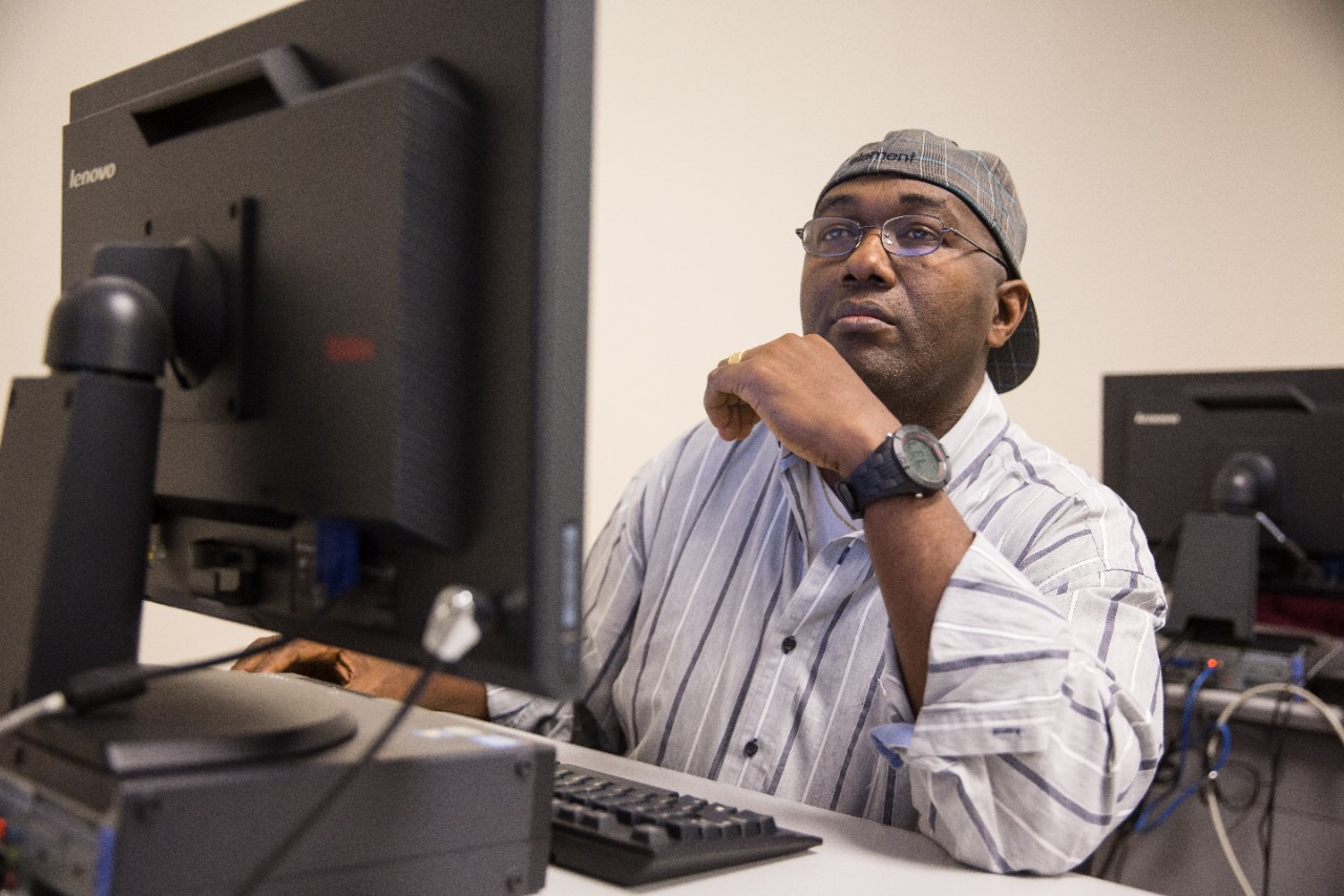 Adult student engaged in online learning at Thomas Jefferson University's School of Professional Studies.