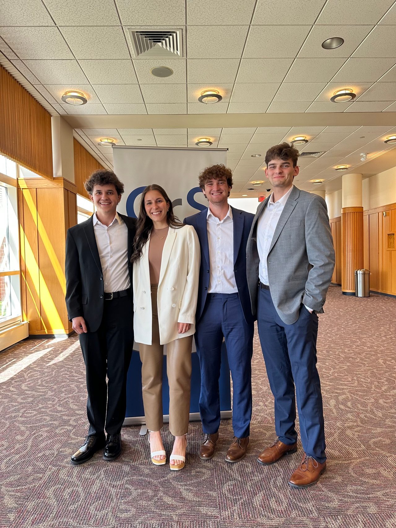 Four students, three male and one female, pose for a picture after taking 2nd place in the Fall ’23 Council for Retail and Sales Case Study Competition.