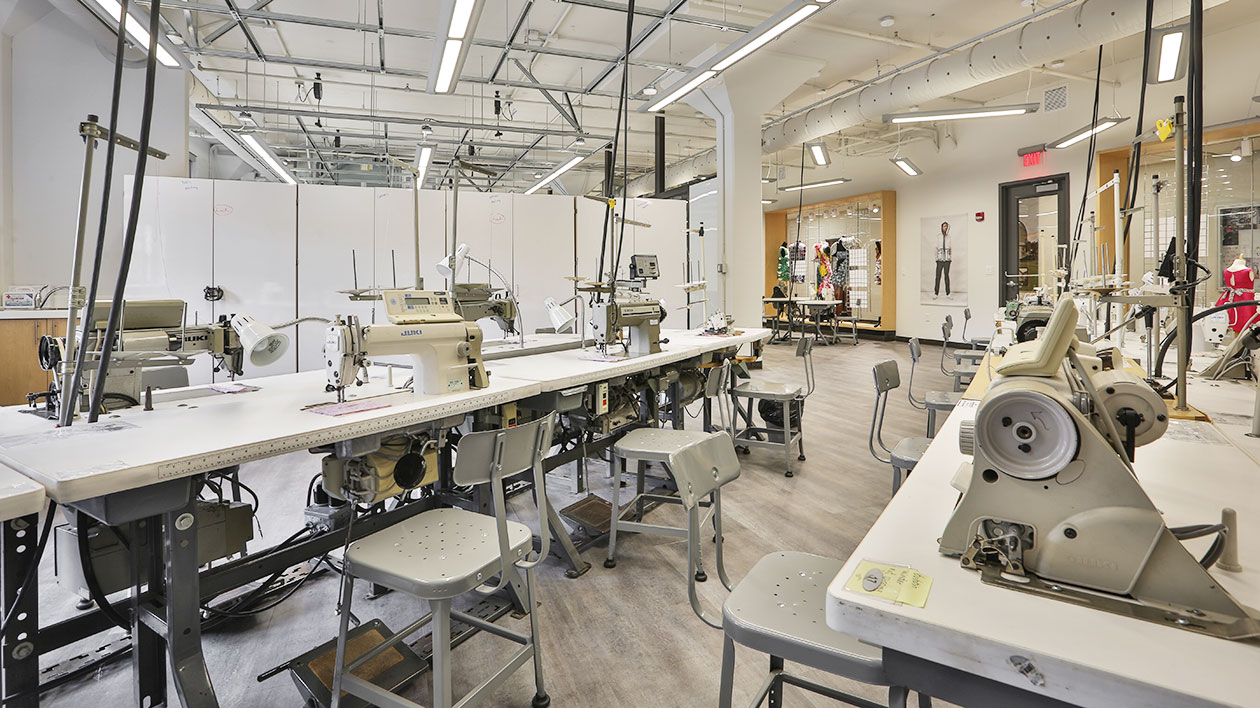 Rows of sewing machine stations inside Thomas Jefferson University's Fashion and Textiles Futures Center