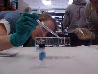 Jefferson student placing sample in a vial
