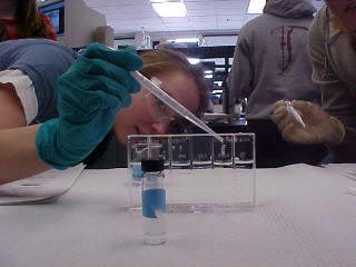 Jefferson student placing sample in a vial
