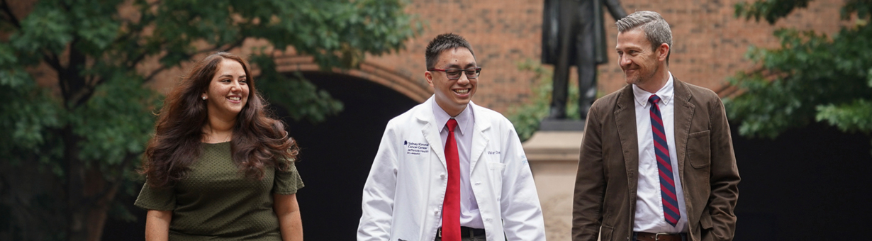 A professor, student, and medical doctor discussing population health strategies at Thomas Jefferson University's Master's in Public Health program