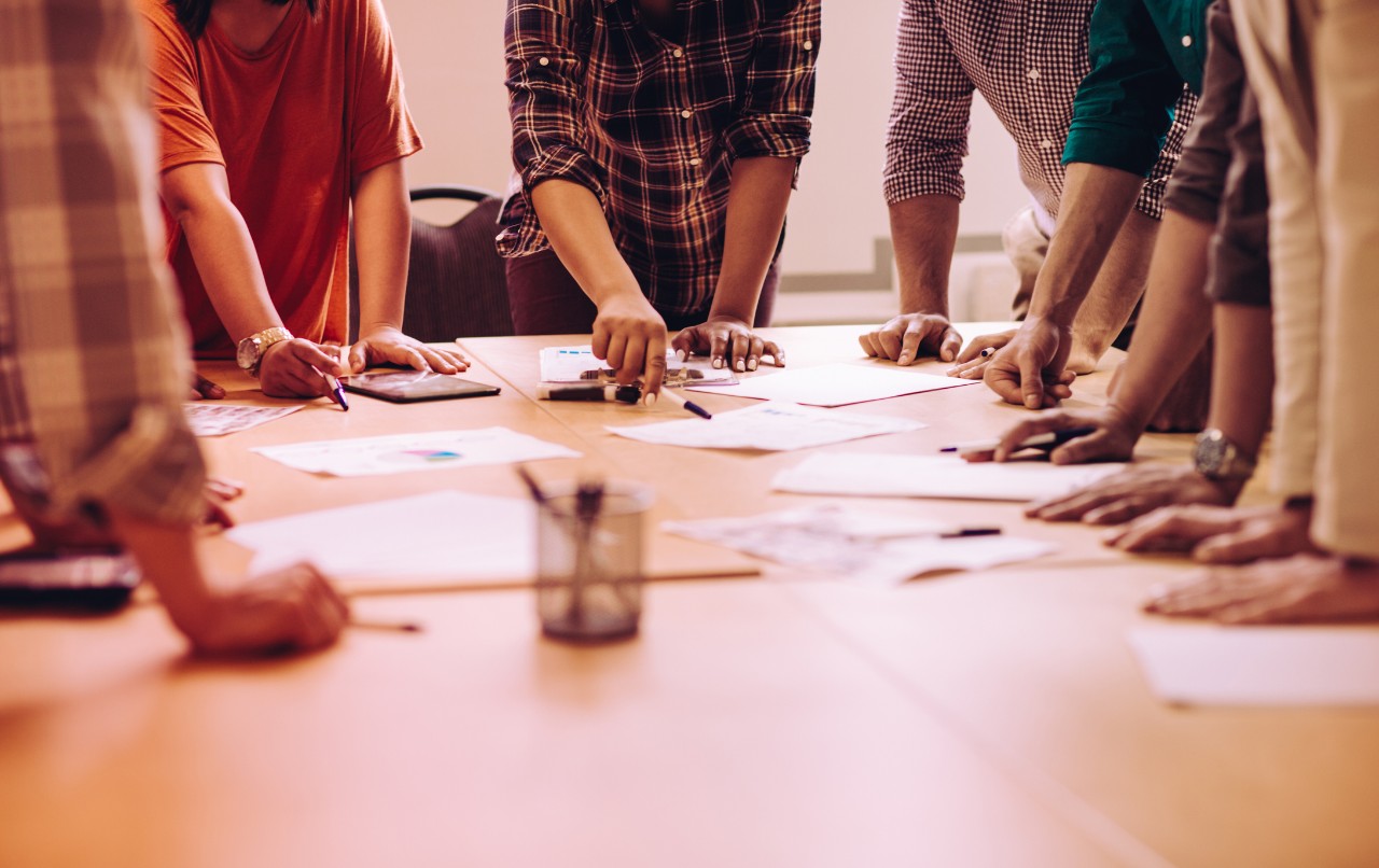 Teamwork concept : hands  over the desk, representing brainstorming moment