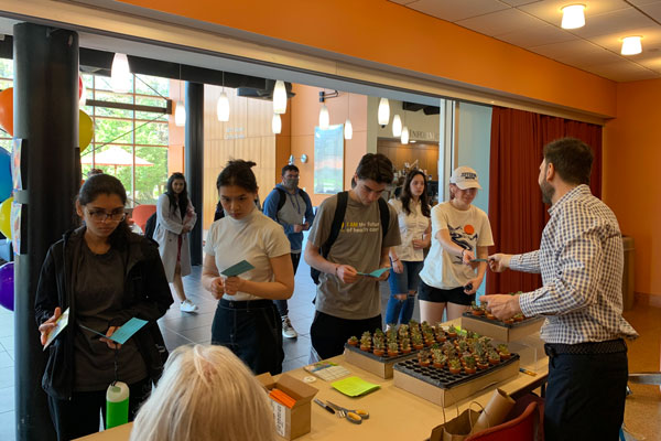 Staff welcoming students to the event.