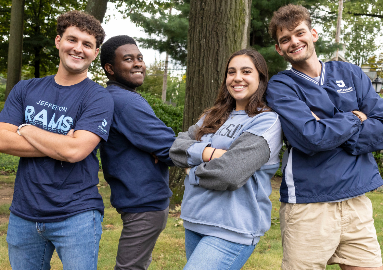 Four students wearing Thomas Jefferson University gear.