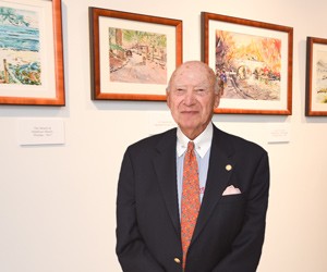 Gerald Marks standing next to an art gallery