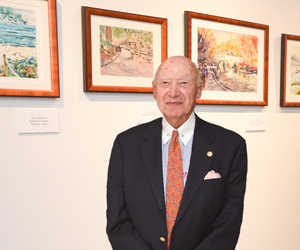 Gerald Marks standing next to an art gallery