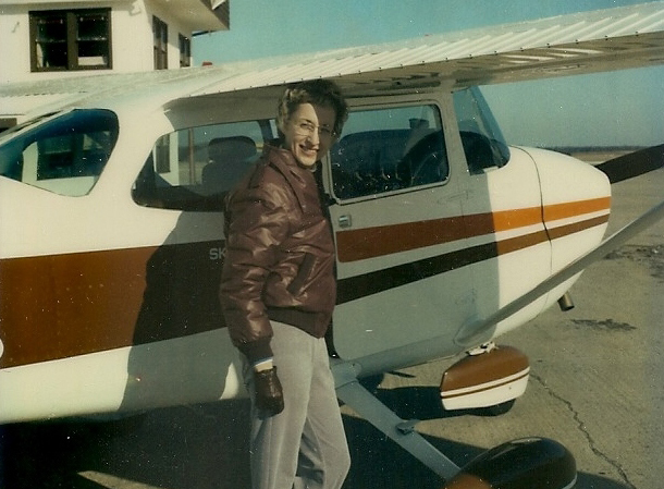 Dr. Lorraine King next to airplane