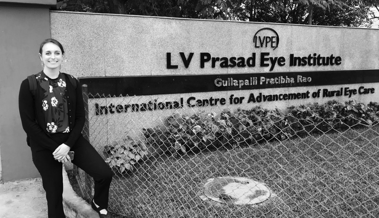 Hannah Garrigan in front of sign for LV Prassad Eye Institute