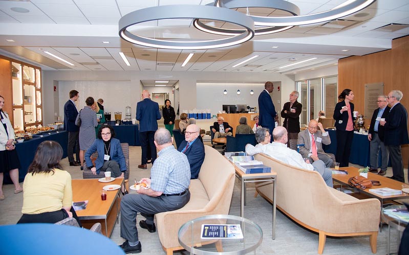 This image shows the Pinizzotto-Ammon Alumni Center with alumni conversing.