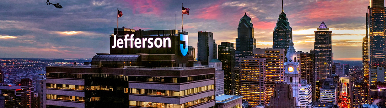 This image shows the Jefferson logo atop a building in the Philadelphia skyline.