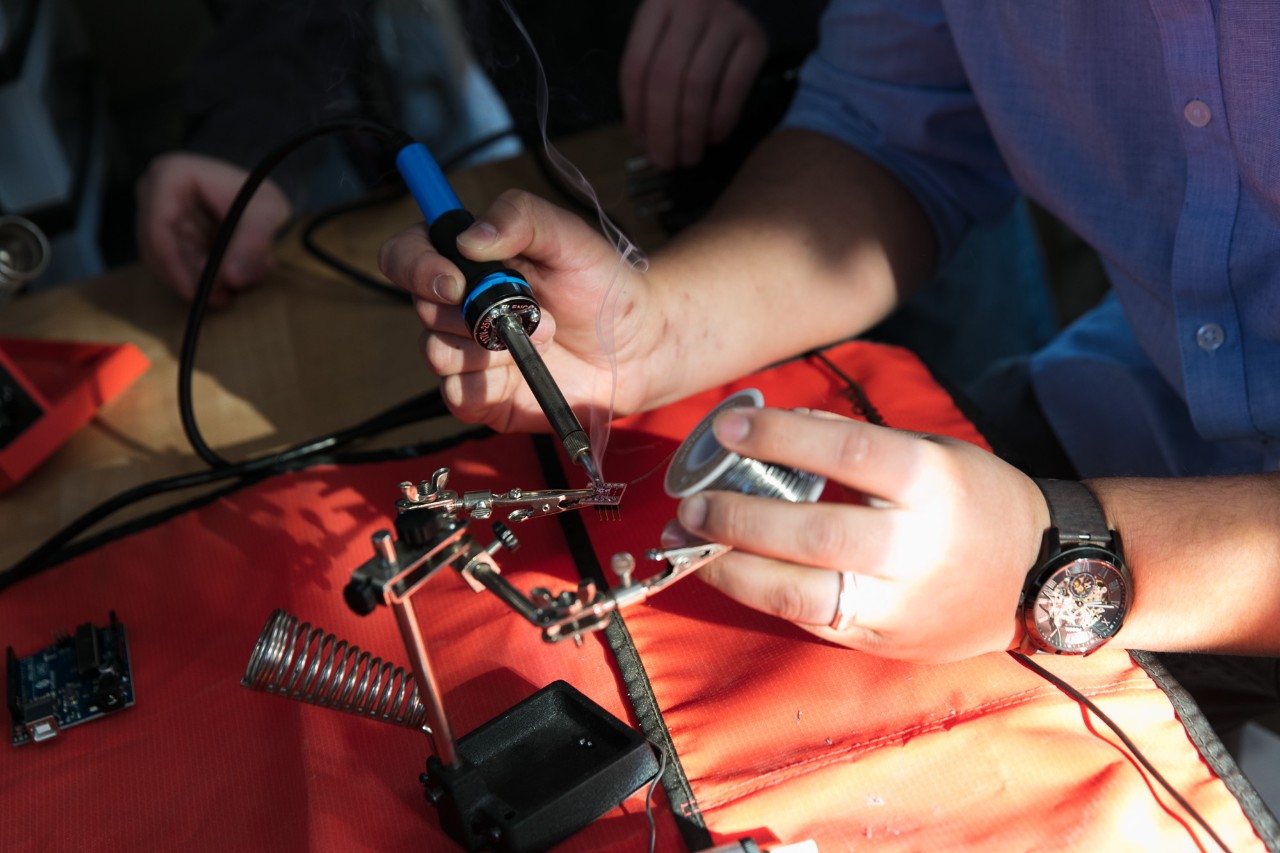 engineering students working on a machine