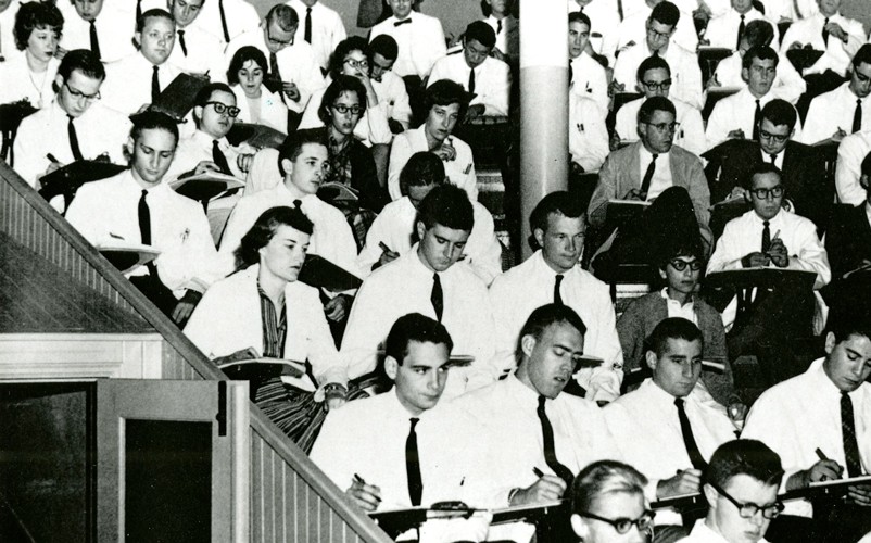 An old photo of a handful of women in a med school class surrounded by primarily men