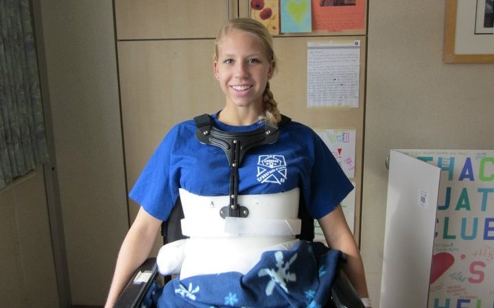 Michelle Konkoly in a back brace and wheelchair