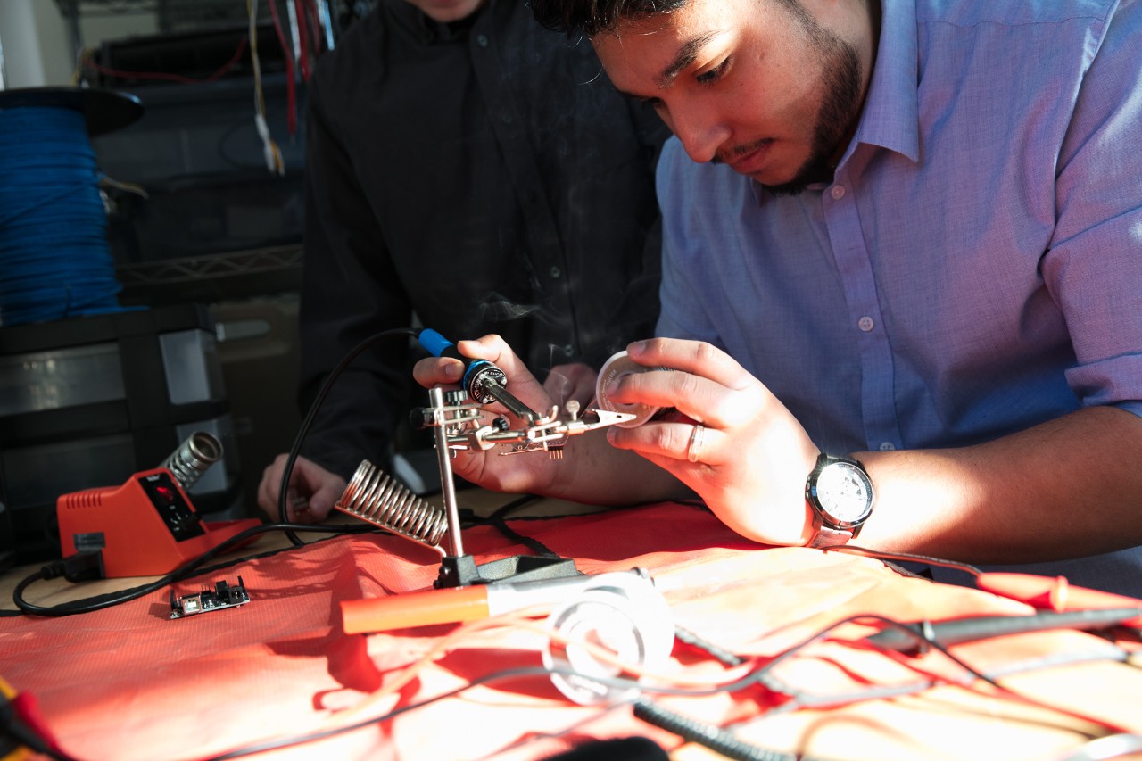 Student working with solder equipment