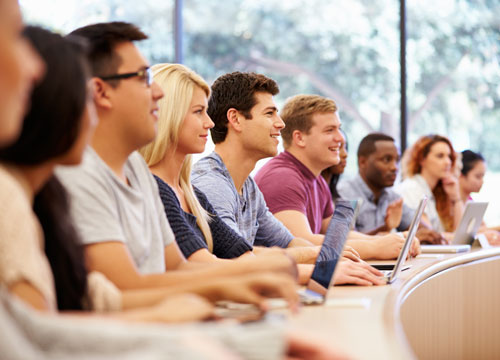 Class Of University Students Using Laptops In Lecture