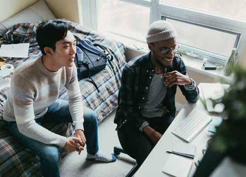 Friends watching a fun video on their computer