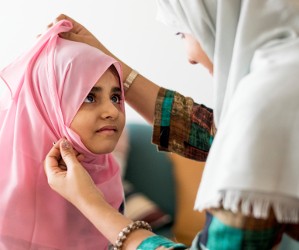 Mom helping daughter with her hijab