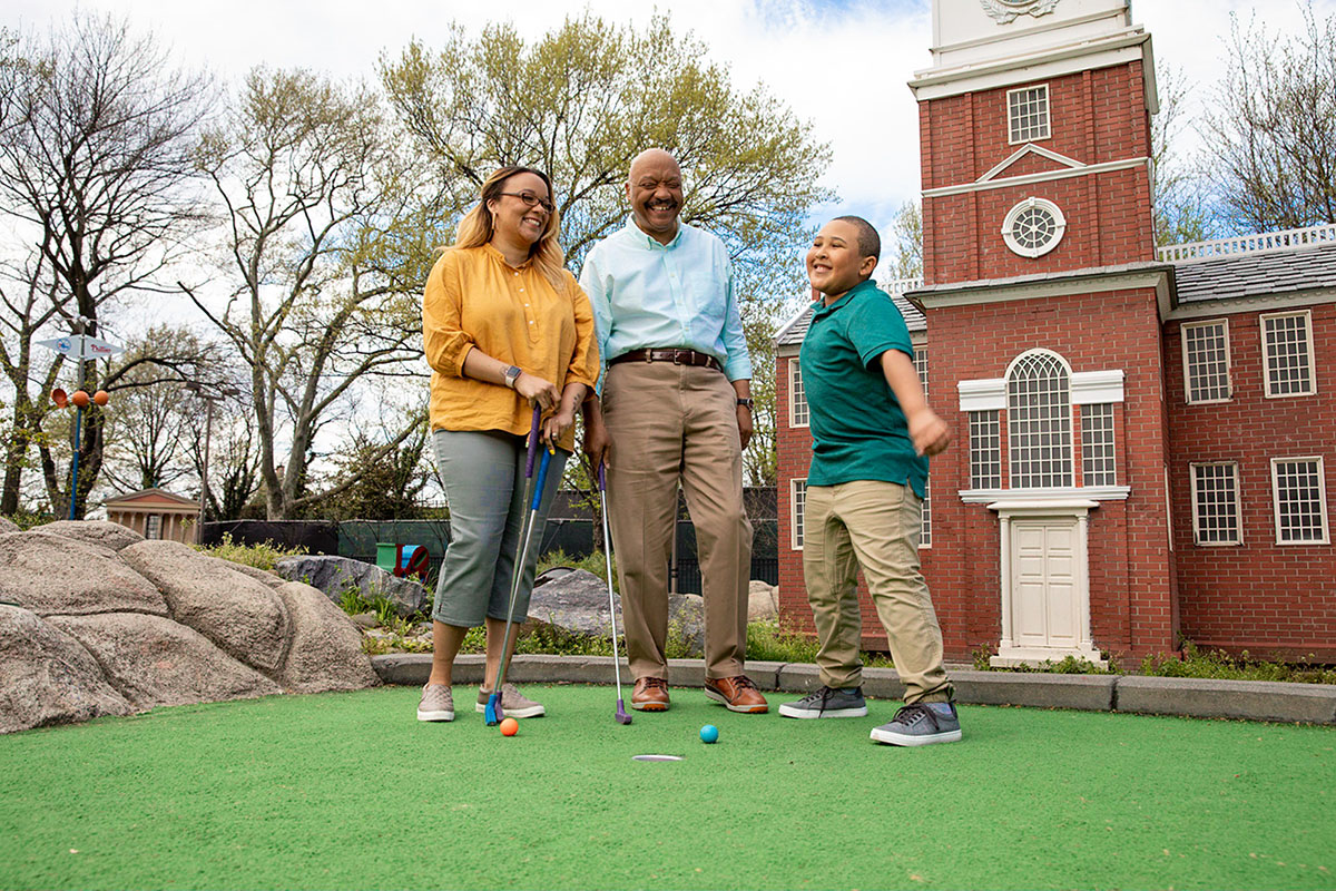 Charles playing mini golf with family