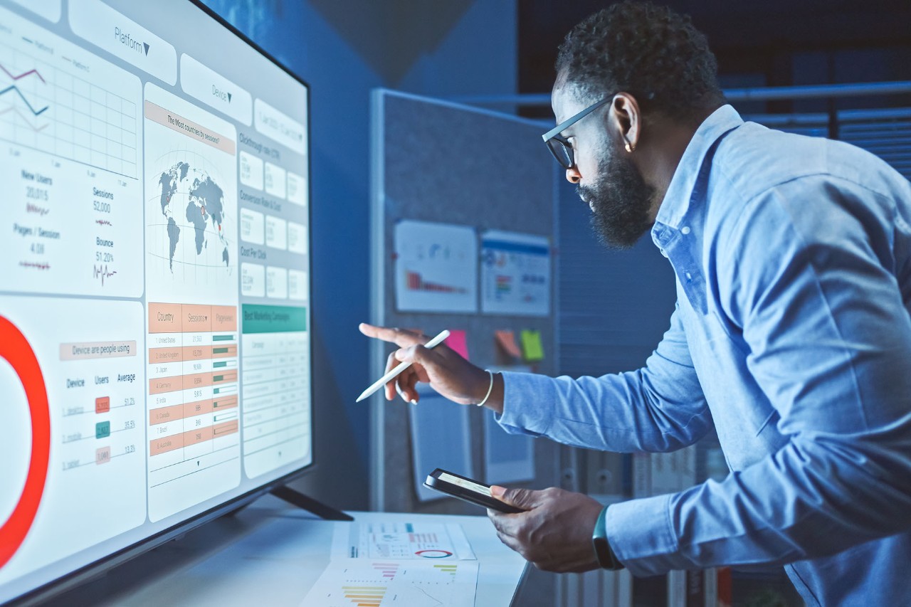 2166193838 A Man Reviews the Data Analysis of Marketing from Social Media Platforms.