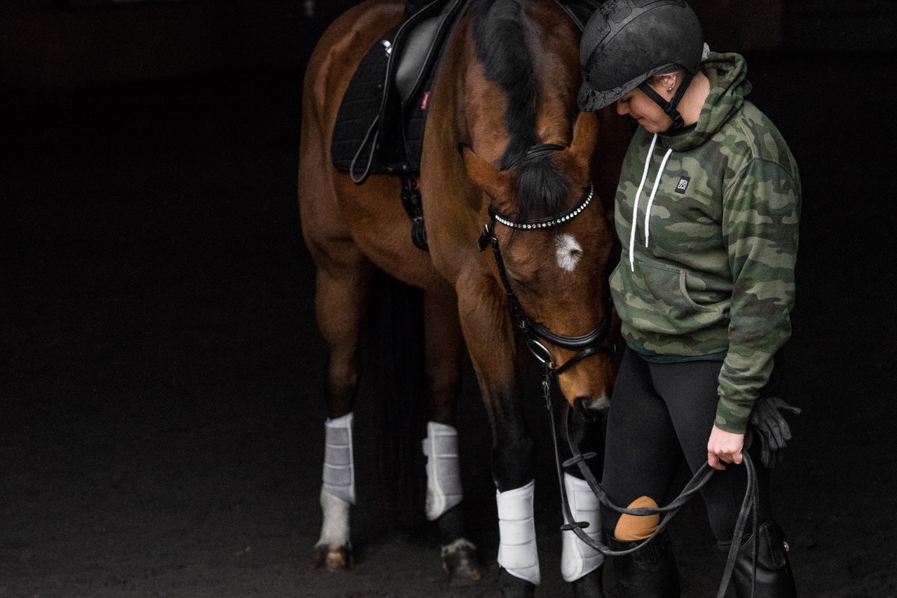 Model poses next to her horse