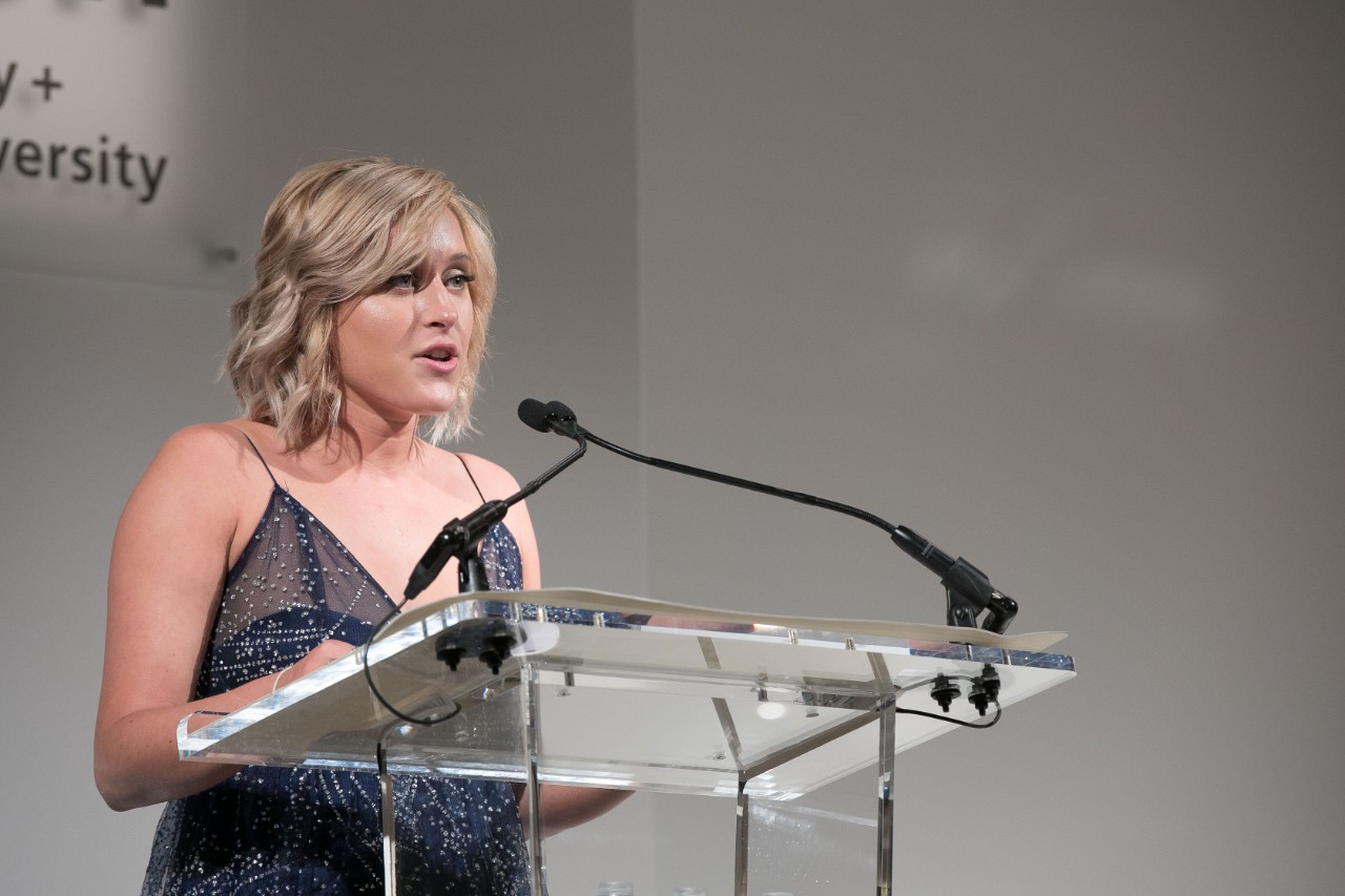 Lauren Vastano speaks at the podium