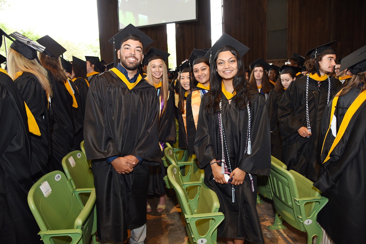 Smiling graduates in their caps and gowns