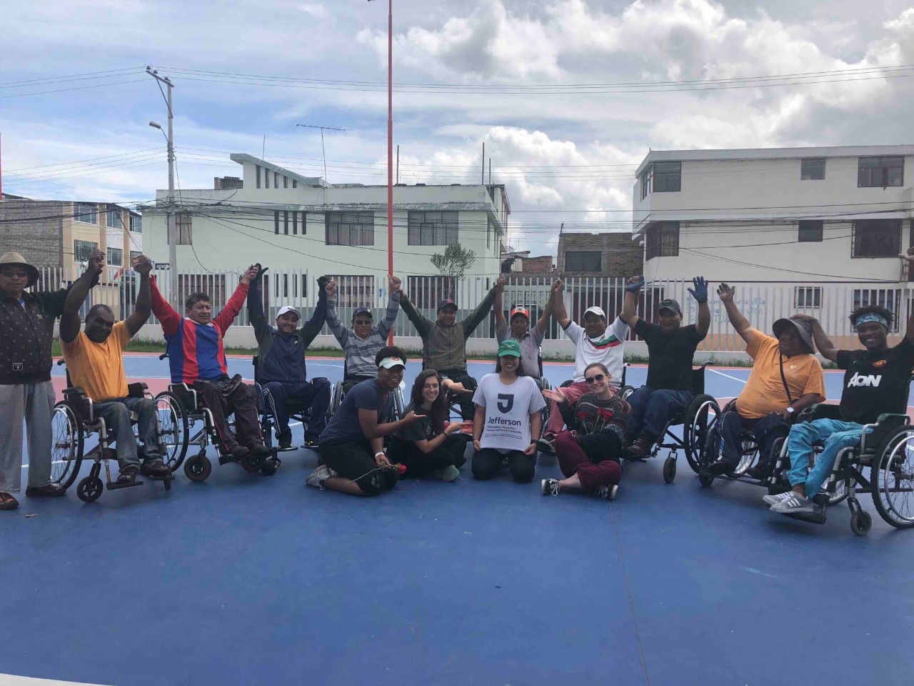 The wheelchair basketball team and Jefferson students pose for a picture.