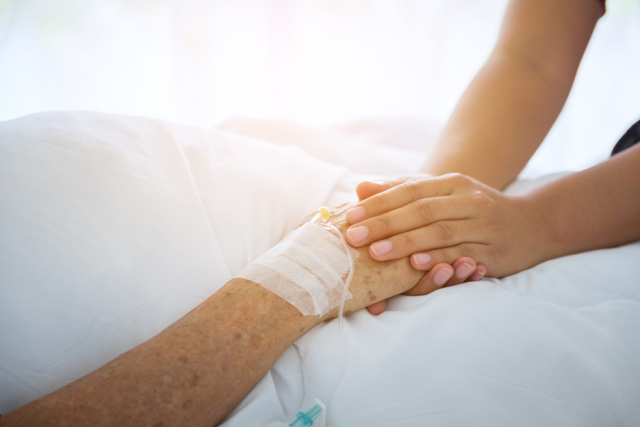 student holding a patient's hand