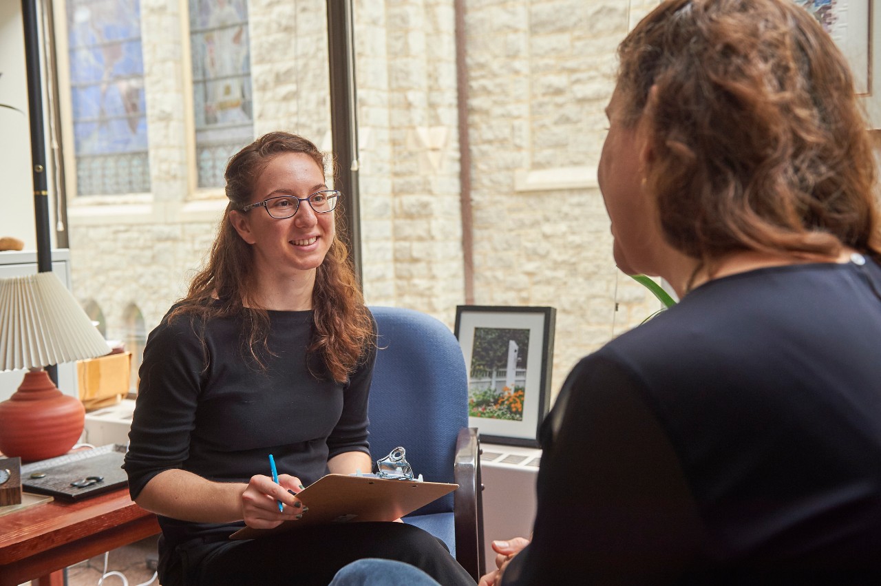 Two women speaking with each other