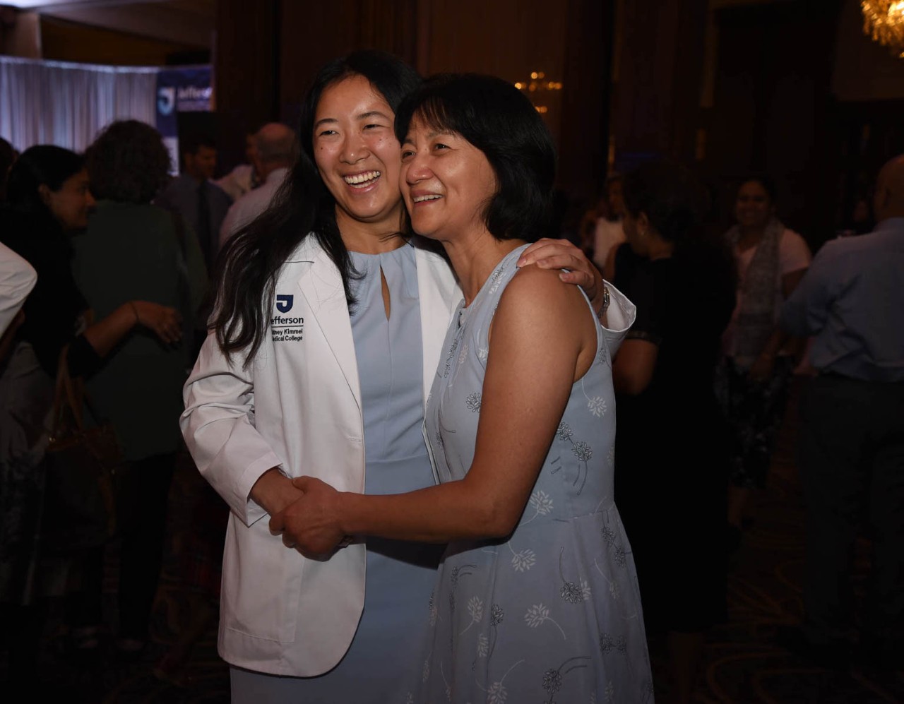 Family members hug at the White Coat Ceremony