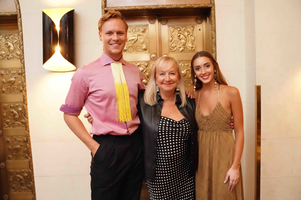 designs pose with fashion design program director