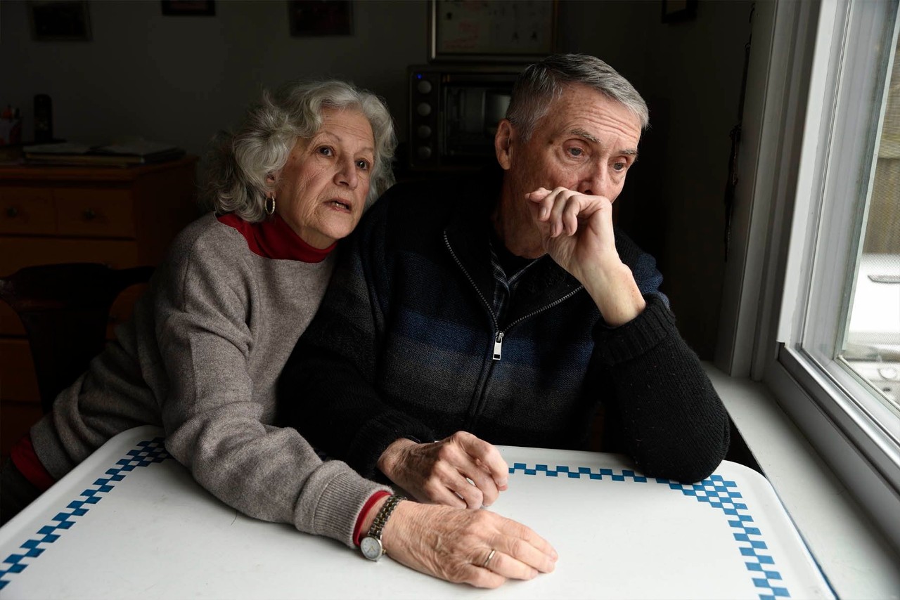 Two senior citizens looking out a window Two senior citizens looking out a window