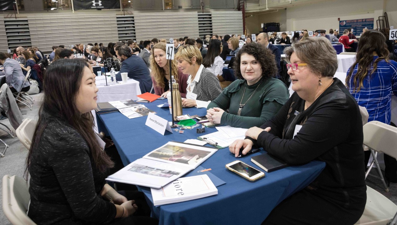 Student shows her portfolio at job fair event