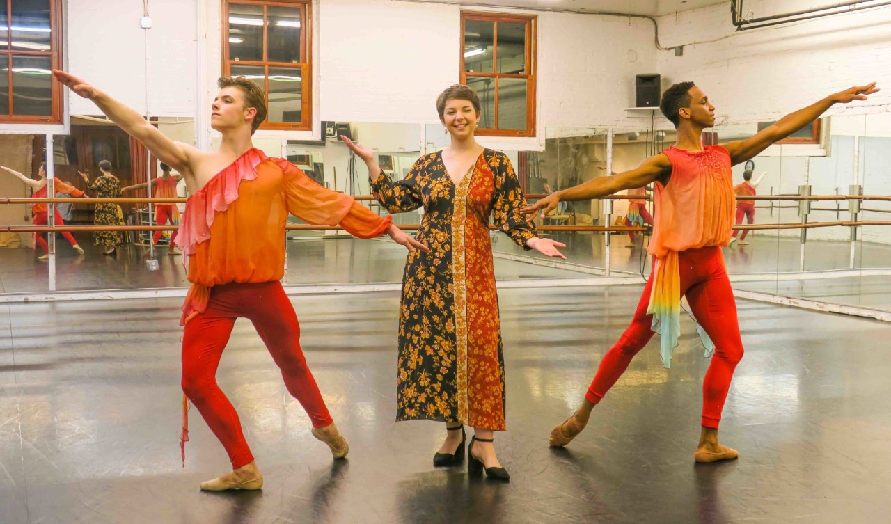 Two dancers pose with a Jefferson fashion student