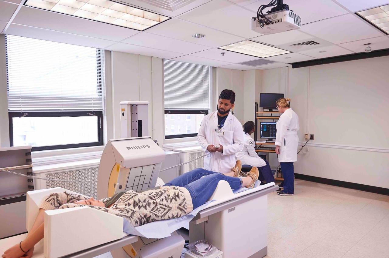 Students working with a patient