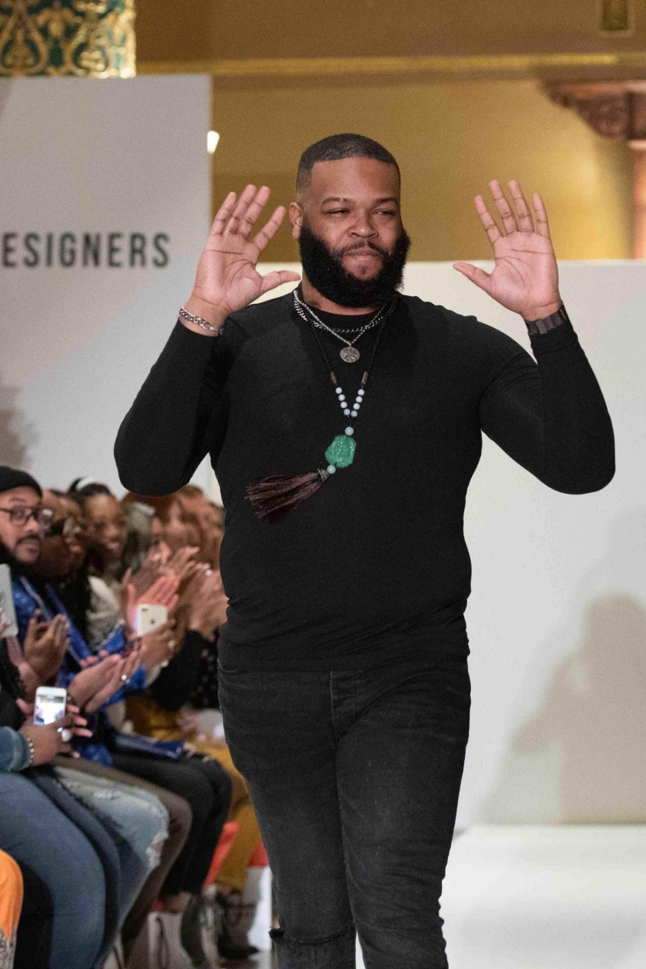 Fashion design student Marquies Smith walks down the runway