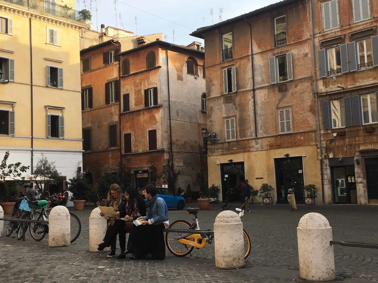 Students sitting outside in a foreign city.